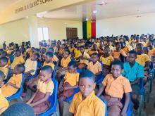 Students seated on chairs in the library meeting hall