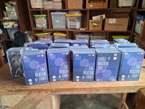 table with 100 blue covered textbooks displayed on it